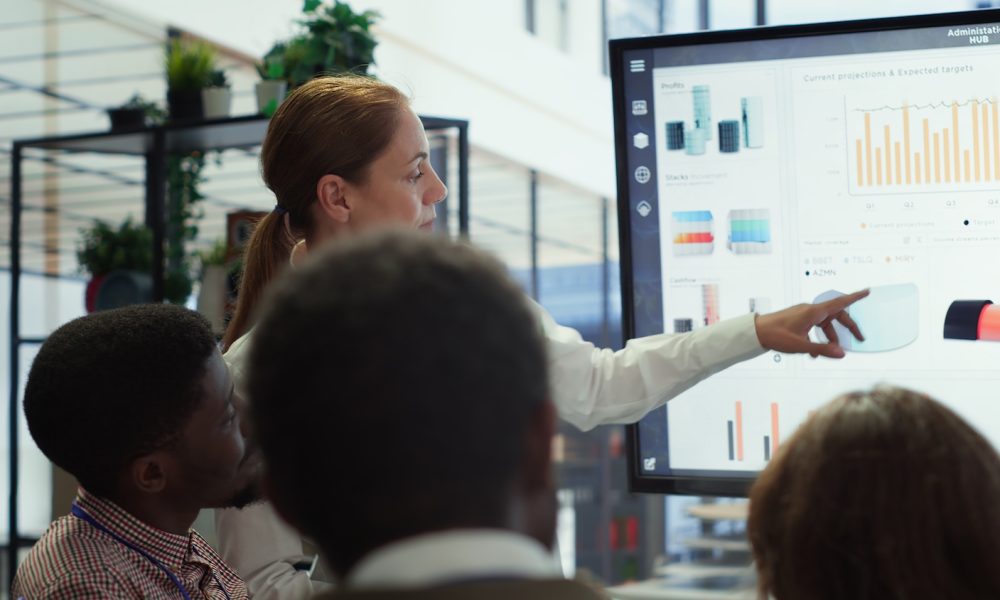 Executive board members meeting in conference room to establish future growth plan, ensuring expansion goals for the multinational company. Big data insights to make informed decisions. Camera A.